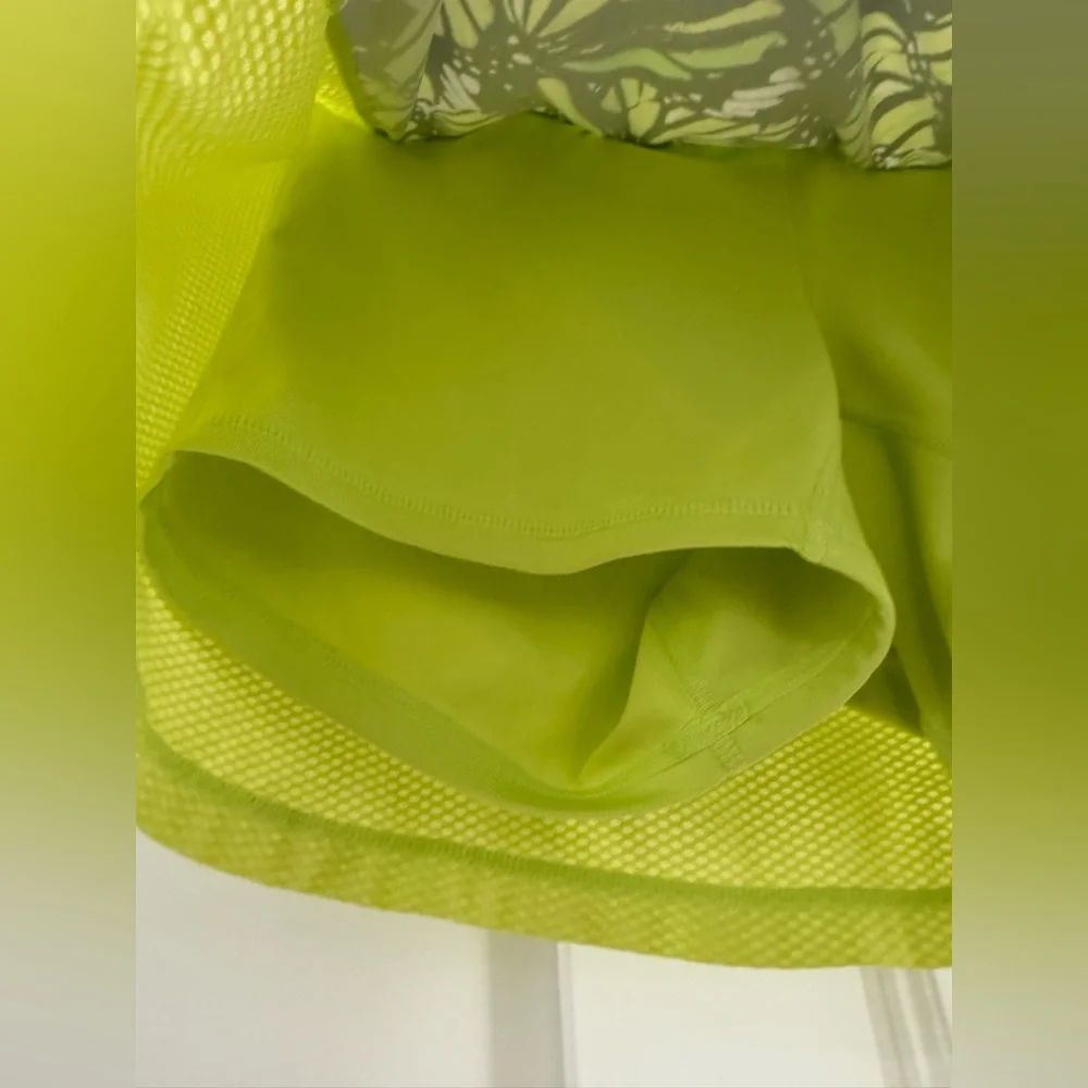 Fila neon yellow green mini skort w/ multicolor butterfly pattern